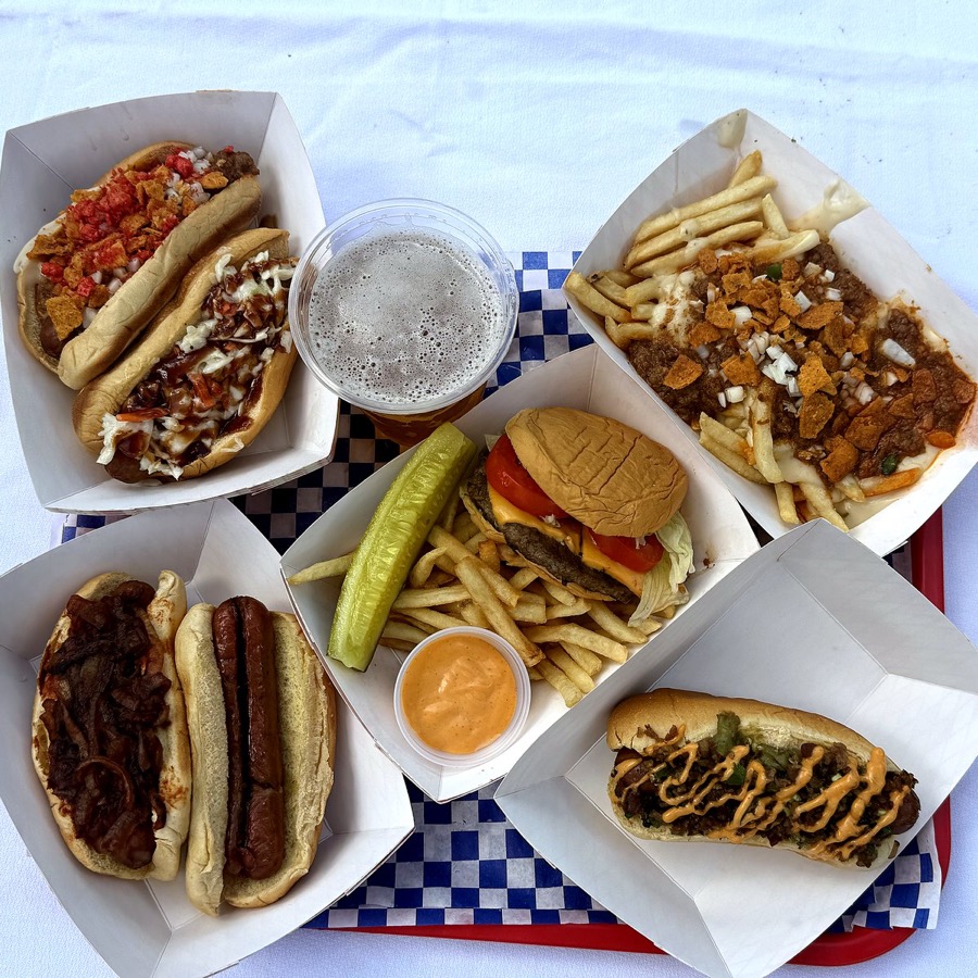 Full spread of hot dogs, burger, and loaded fries